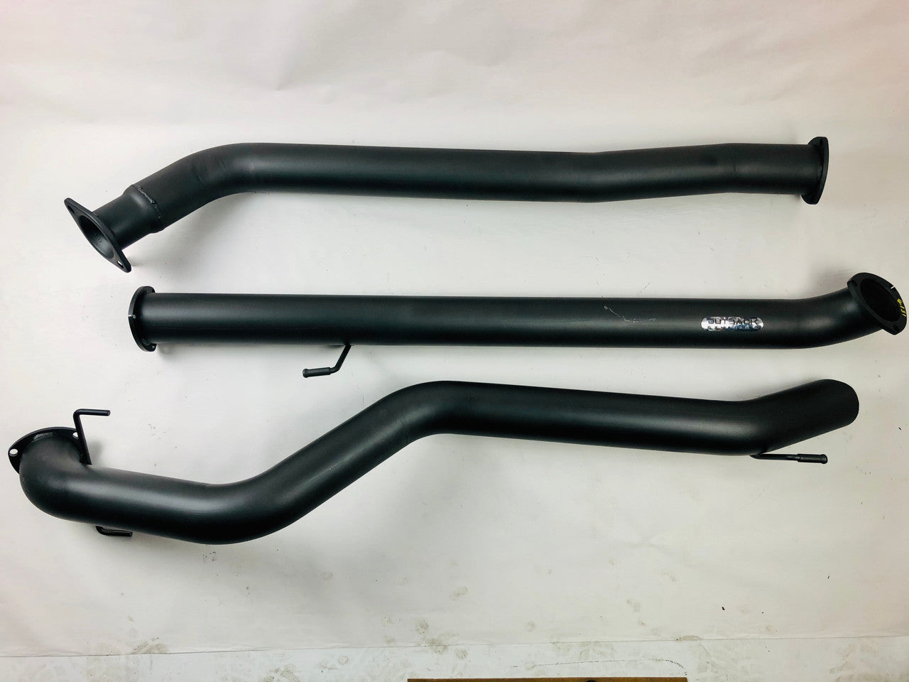 Image of a 3.5 inch Outback Exhausts DPF back system designed for a Toyota Hilux N80 2.8Ltr 4 Cyl GUN126R Turbo Diesel. The system features mandrel-bent 409 stainless steel pipes with welded flanges at both ends and mounting brackets. The system is displayed against a transparent background. SKU OE4668-S35.