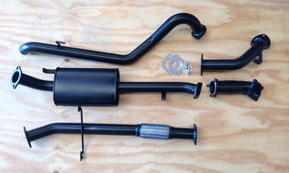 Image of a 2.5 inch Outback Exhausts  turbo back system designed for a Mitsubishi Pajero 2.8L NJ-NK-NL 4M4O engine. The system features mandrel bent 409 Stainless Steel pipes and muffler displayed against a wooden background. SKU:OE3408-S