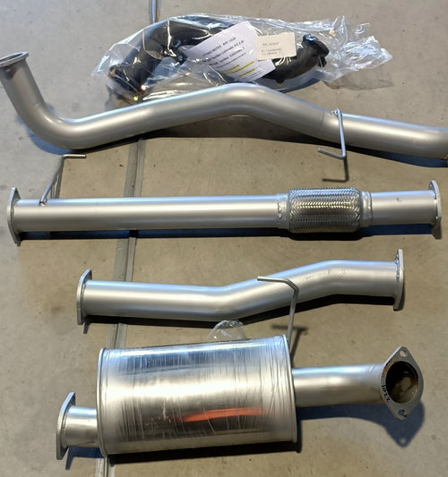 Image of a 3-inch Outback Exhausts  Turbo back system designed for a Holden Colorado 7 Duramax Turbo Diesel Engine. The system features mandrel-bent 409 stainless steel pipes with welded flanges at both ends and mounting brackets. One of the pipes includes a muffler.  The system is displayed against a concrete background .  SKU OE1609-S.